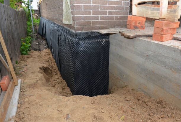 SJ Waterproofing Pros technician performing targeted Basement Waterproofing assessment in Ovid, MI